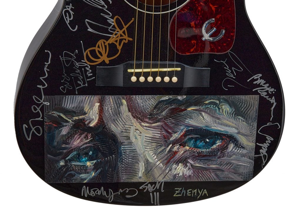 A 2014 black Epiphone acoustic guitar signed by various artists who participated in the tribute concert honoring Bob Dylan upon his being awarded MusiCares Person of the Year in 2015. Photo: Courtesy of Julien's Auctions.