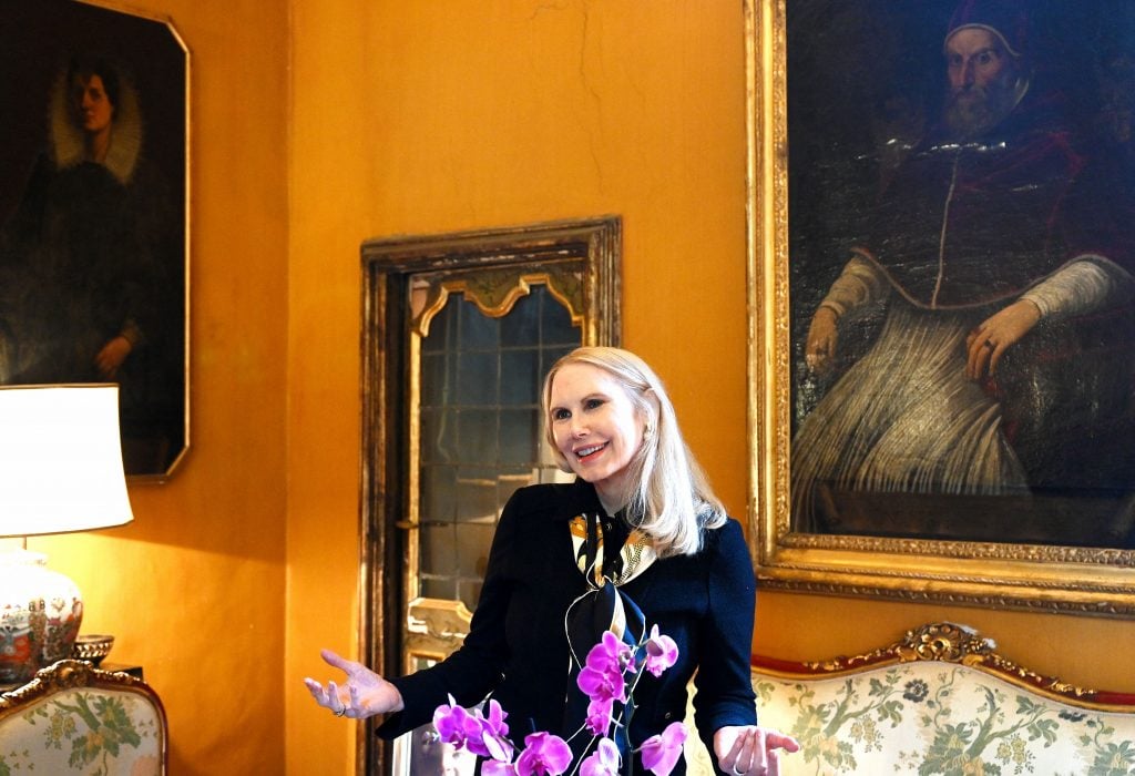 Princess Rita Jenrette Boncompagni Ludovisi posing in front of a painting of Pope Gregorio XV at the Villa Aurora, or Casino di Villa Boncompagni Ludovisi, in Rome. The property, home to the only ceiling mural by Caravaggio, is being auctioned to resolve an inheritance dispute, but has thus far failed to find a buyer. The princess has vowed to fight a judge's eviction order. Photo by Vincenzo Pinto/AFP via Getty Images.