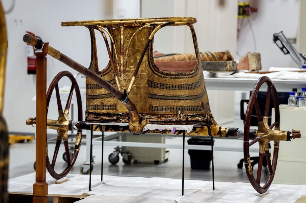Golden chariot of Pharaoh Tutankhamun as it lies for restoration at the restoration lab of the newly-built Grand Egyptian Museum (GEM) in Giza. Photo: MOHAMED EL-SHAHED/AFP via Getty Images.
