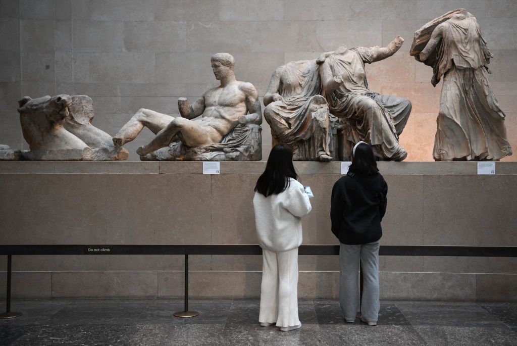 Visitors view the Parthenon Marbles, also known as the Elgin Marbles, at the British Museum in London on January 9, 2023. Photo by Daniel Leal/AFP via Getty Images.