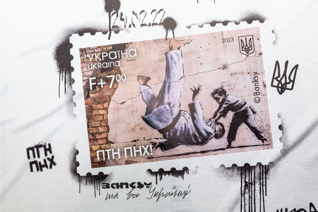 A billboard presents the new FCK PTN stamps which has its premiere on the anniversary of Russian invasion and uses the artwork by Banksy in the Central Post Office in Old Town Kyiv, the capital of Ukraine on February 24, 2023. Photo by Dominika Zarzycka/NurPhoto via Getty Images.