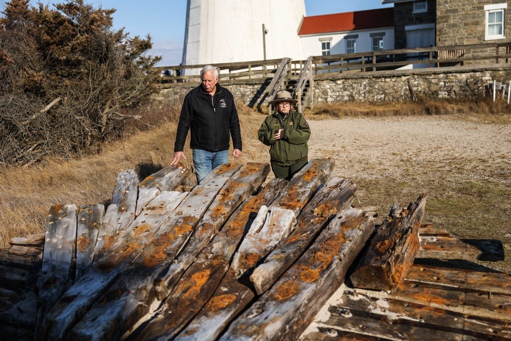 Tony Femminella of the Fire Island Lighthouse Preservation Society and Betsy DeMaria of Fire Island National Seashore stand next to a section of the hull of a ship believed to be the SS Savannah. Photo: Steve Pfost/Newsday RM via Getty Images.