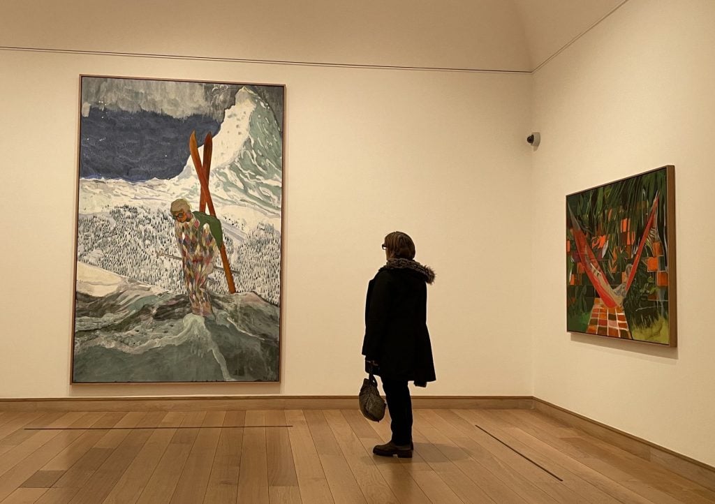 A viewer admiring Peter Doig's paintings, <i>Alpinist</i> (left), and <i>Alice at Boscoe's</i> at the Coutauld Gallery in London. Photo: Vivienne Chow. 