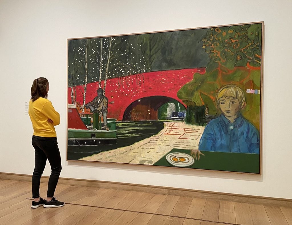 A viewer admires Canal (2023), one of the most recent paintings by Peter Doig in his self-titled exhibition at the Courtauld Gallery in London. Photo: Vivienne Chow.