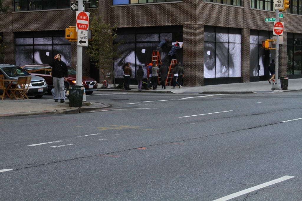 Work of artist JR being installed at Story in Chelsea. Photo: Marc Azoulay.