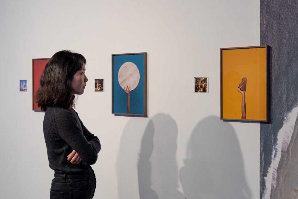 A viewer admiring Audrey Albert's work <i>Matter Out of Place</i> on show at exhibition "Practise Till We Meet" at Esea Contemporary. Photo: Jules Lister. 