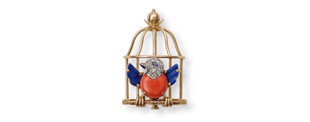 'Oiseau Libéré' brooch, Cartier Paris, 1947. Gold, platinum, rose-cut diamonds, one sapphire cabochon (eye), coral, lapis lazuli. During World War II, Cartier designed various pieces featuring caged birds, symbolizing occupied France. Once Paris was liberated, jewels were designed with the patriotically-colored bird bursting from its cage in an explosion of joy. Photo: Nils Herrmann, courtesy of Cartier.