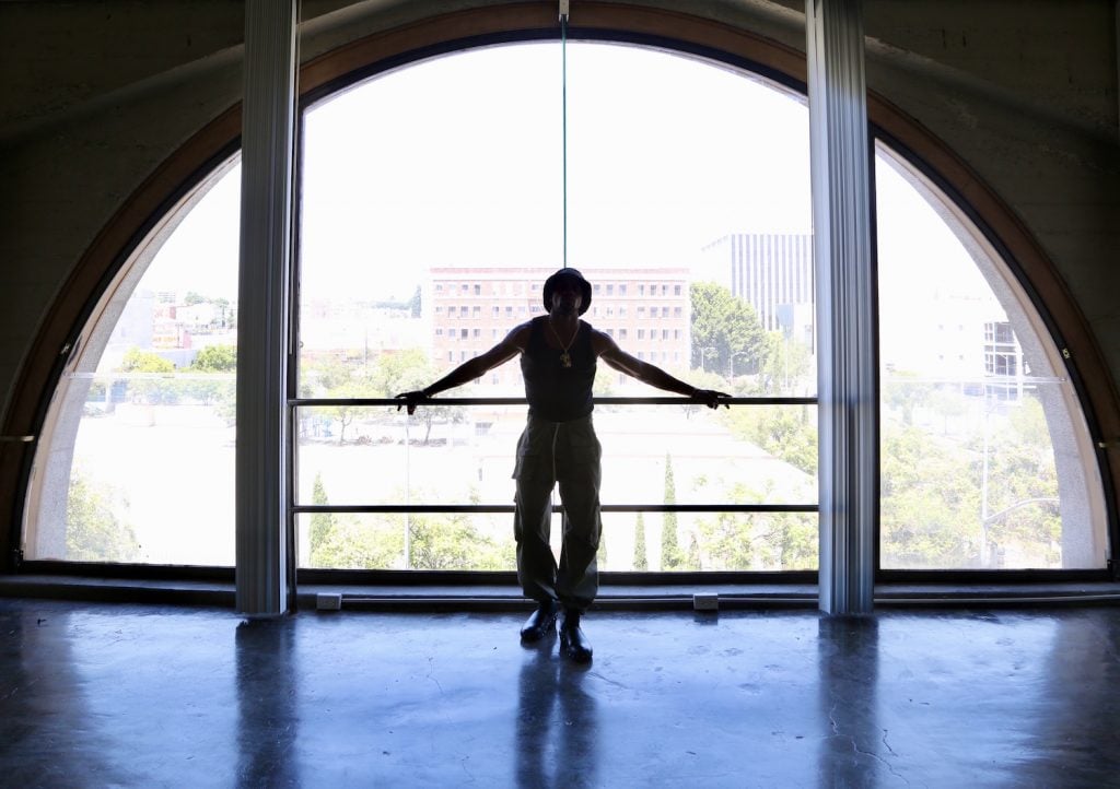 Daniel Tyree Gaitor-Lomack in his downtown Los Angeles space under the ‘arc window’ . <br>Image courtesy the artist.