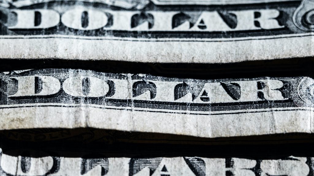 Extreme close-up of U.S. dollar bills layered on top of one another. Photo: Silas Stein/dpa (Photo by Silas Stein/picture alliance via Getty Images)
