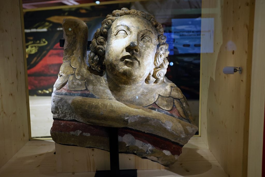A polychrome angel's head from Notre Dame cathedral on view in "Notre Dame de Paris: at the heart of the construction site," a new underground exhibition in the forecourt of the cathedral. Photo by Thierry Chesnot/Getty Images.