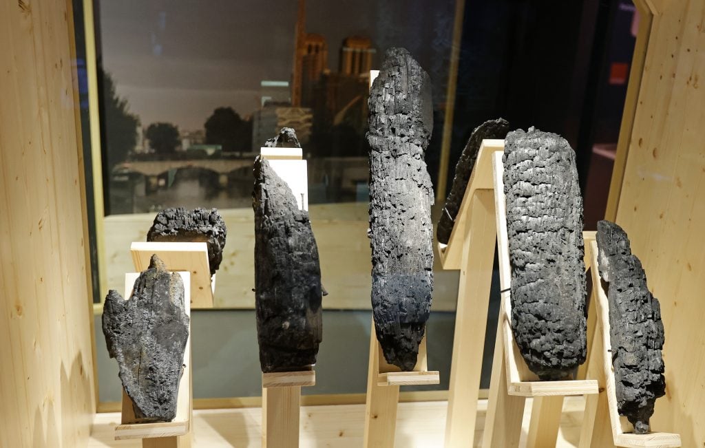 Remnants of charred wood from Notre Dame cathedral are displayed during "Notre Dame de Paris: at the heart of the construction site," a new underground exhibition in the forecourt of the cathedral. Photo by Thierry Chesnot/Getty Images.