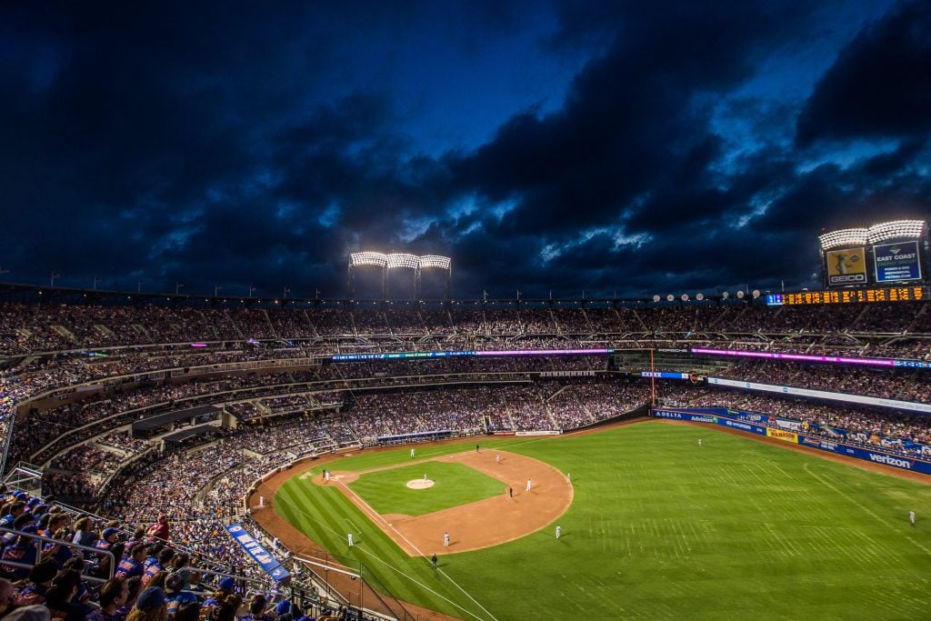 Citi Field at dusk during a game between the New York Mets and the Los Angeles Dodgers in 2017. Photo by Rob Tringali/SportsChrome/Getty Images.