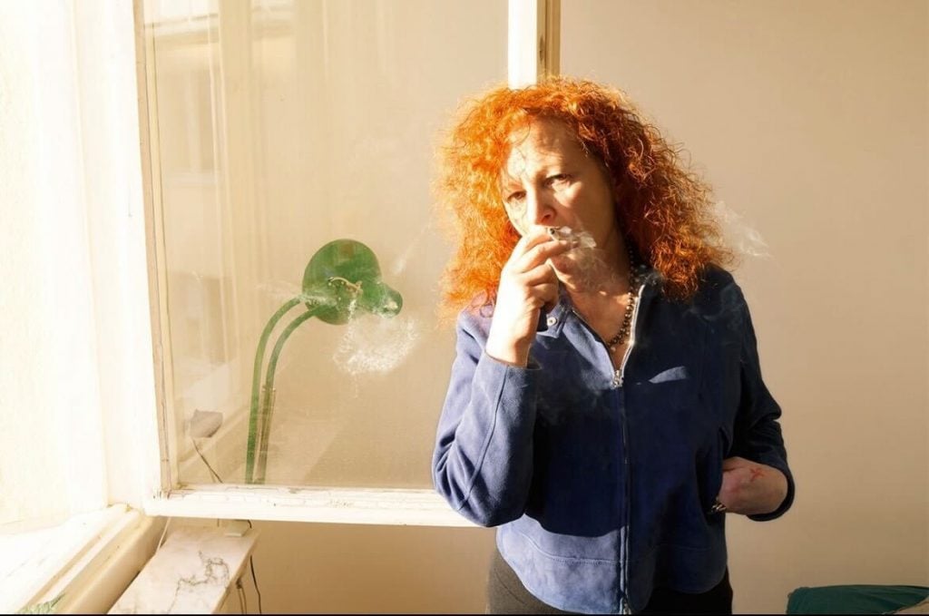 Nan Goldin, Self-portrait smoking, Simon’s house, Stockholm, (2013). © Nan Goldin.