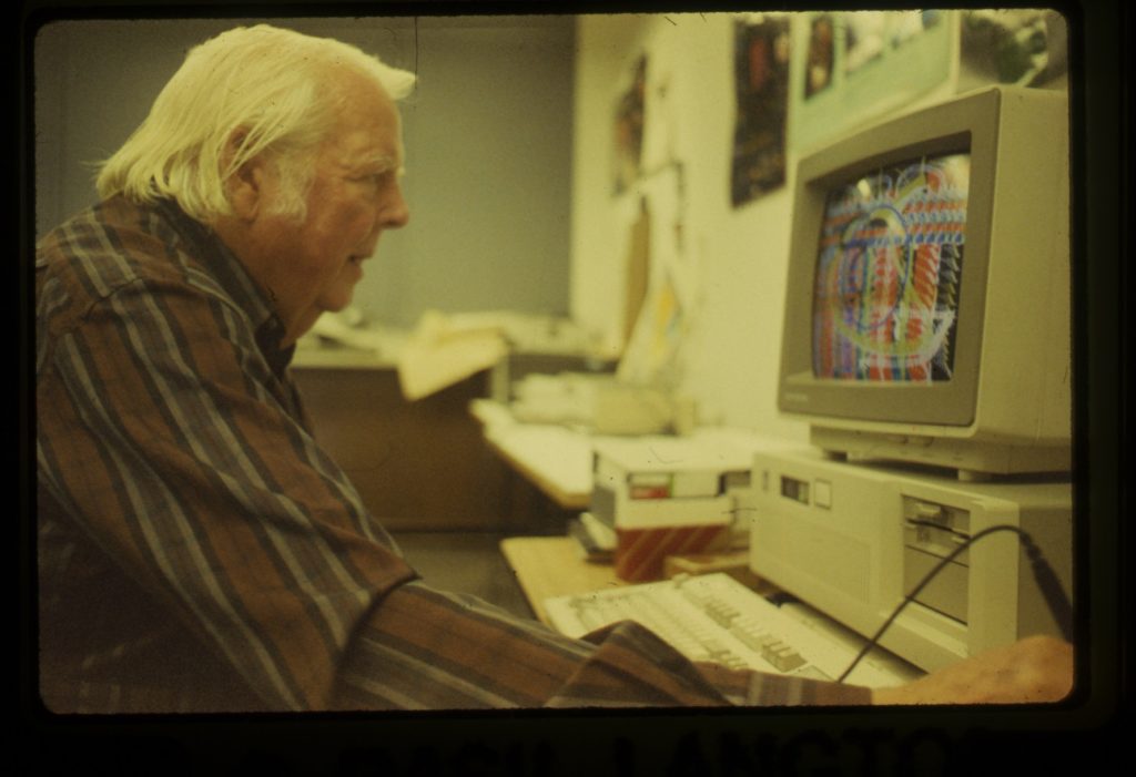 Lee Mullican at the computer (1987). Photo: Basil Langton, courtesy of the Estate of Lee Mullican and Feral File.