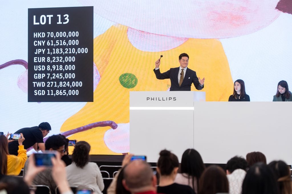Phillips Asia Chairman Jonathan Crockett selling lot 13, Yoshitomo Nara’s Lookin' for a Treasure. Courtesy of Phillips.