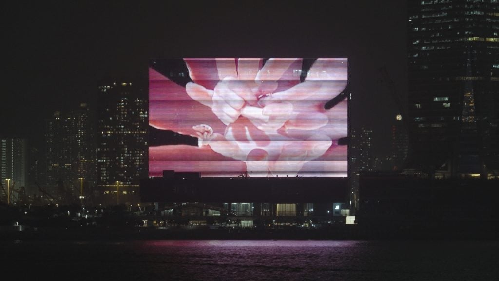 <i>Hand Me Your Trust</i> on the M+ Facade, 2023. Courtesy of Pipilotti Rist and M+, Hong Kong. Photo: Moving Image Studio. M+, Hong Kong.