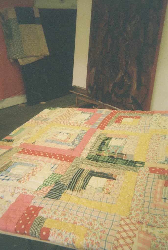 An old quilt that I am about to paint with newer paintings in the background. Atlanta.
