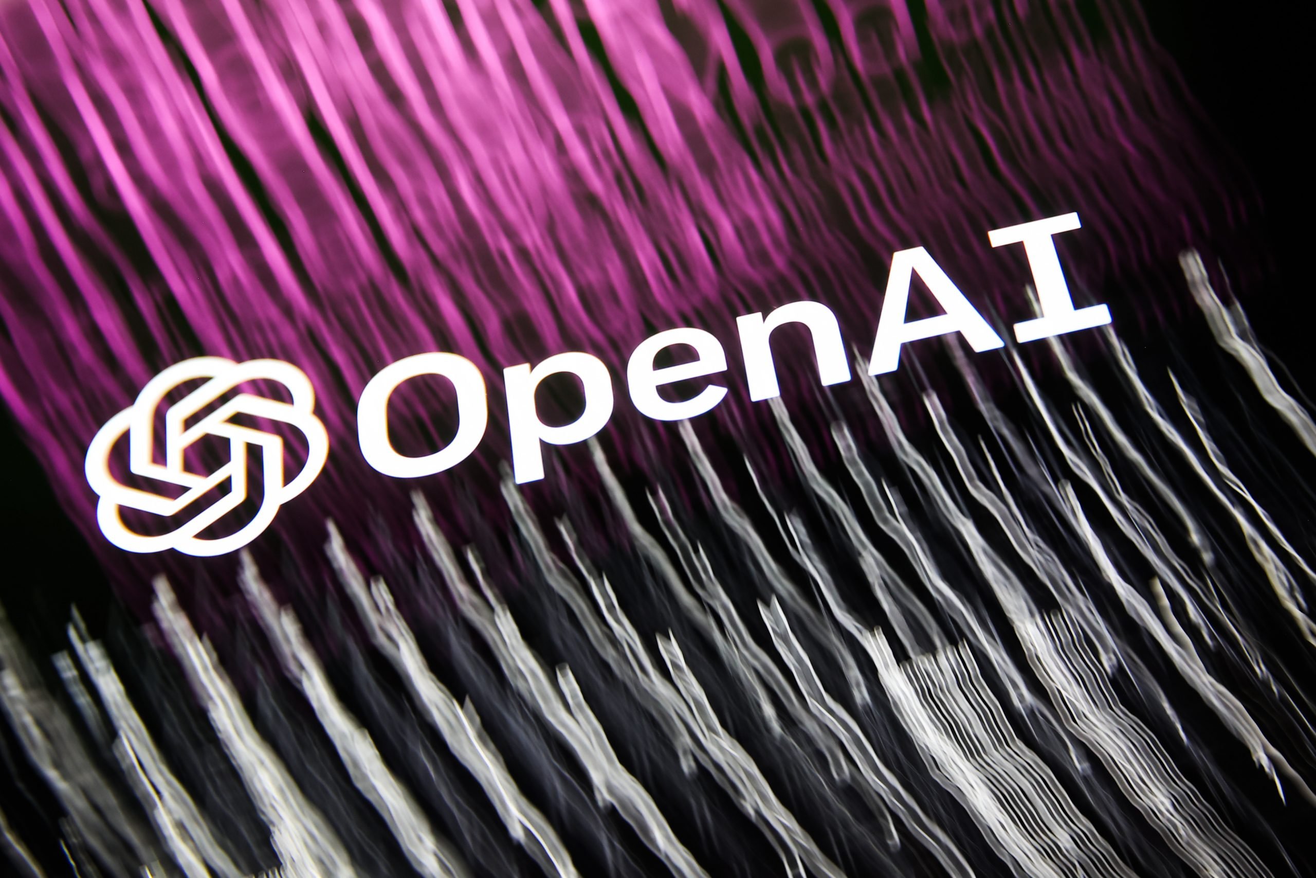 A multiple-exposure photo illustration of GPT-4 and DALL-E developer OpenAI's logo transposed against screens depicting the company's product. (Photo by Jakub Porzycki/NurPhoto via Getty Images)