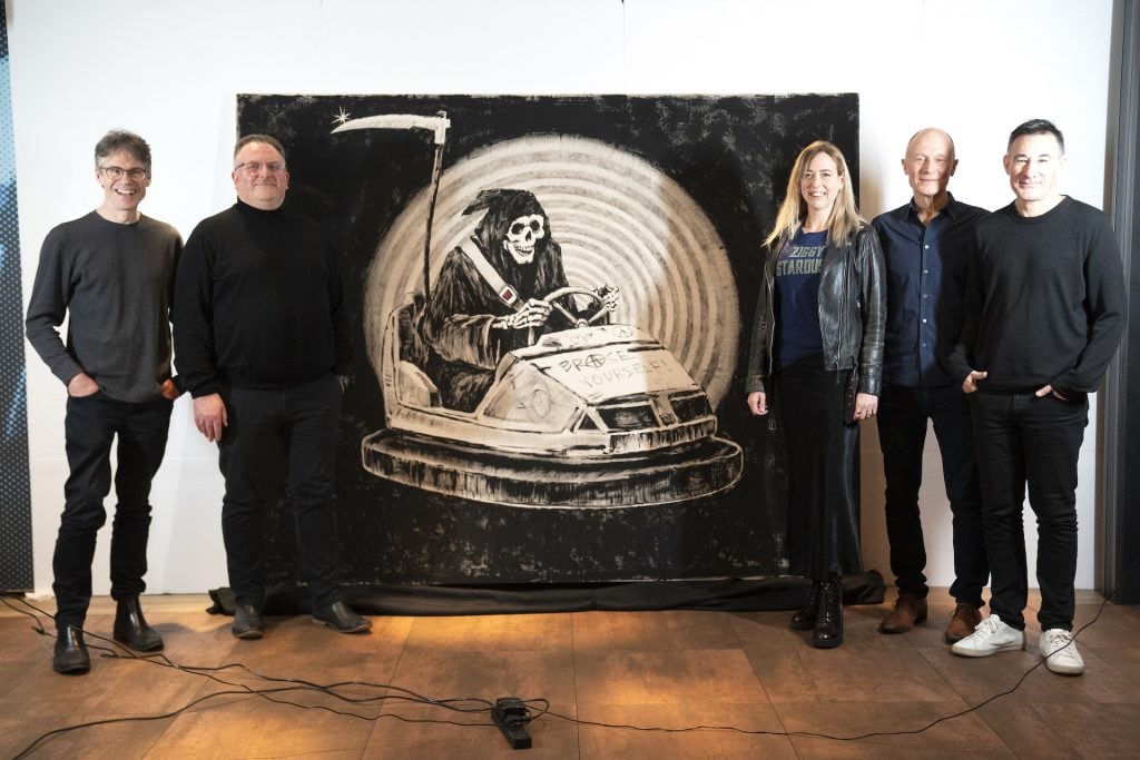 Brace Yourself! band members with Banksy's original grim reaper painting Brace Yourself!, at the Hard Rock Cafe in London ahead of it being offered for sale by Julien's Auctions in Los Angeles. Picture date: Thursday March 9, 2023. (Photo by Kirsty O'Connor/PA Images via Getty Images)