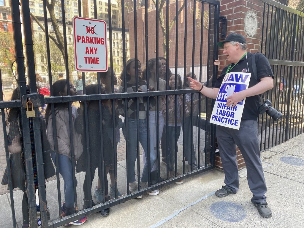 Patrick Lenaghan, the curator of prints, photographs, and sculpture at New York's Hispanic Society Museum and Library explains a union rally outside the Upper East Side home of museum chairman Philippe de Montebello to to curious school children. Photo by Sarah Cascone. 