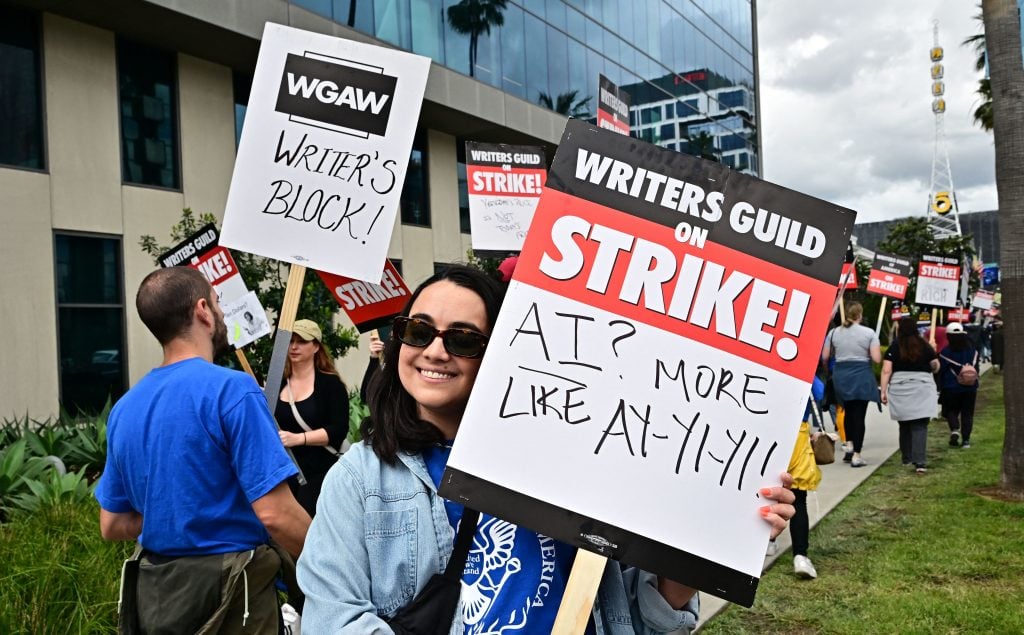Writer Ilana Pena holds her sign on the Writers Guild of America picket line in front of Netflix headquarters in Hollywood on May 5, 2023. (Photo by Frederic J. BROWN / AFP) (Photo by FREDERIC J. BROWN/AFP via Getty Images)