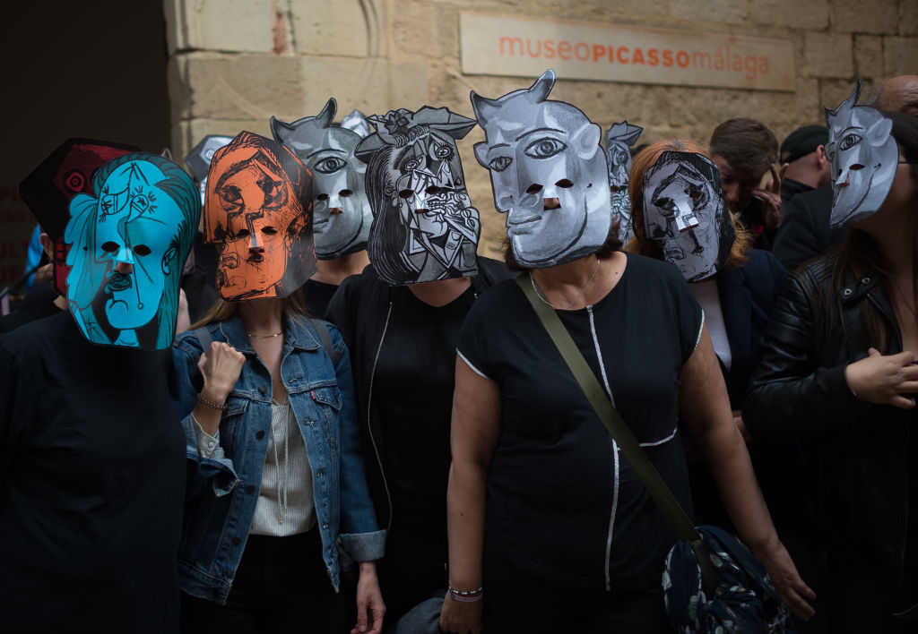 Workers wearing Picasso-style masks take part in a silent protest outside the Picasso Museum, to demand better salary and working conditions. Photo by Jesus Merida/SOPA Images/LightRocket via Getty Images.