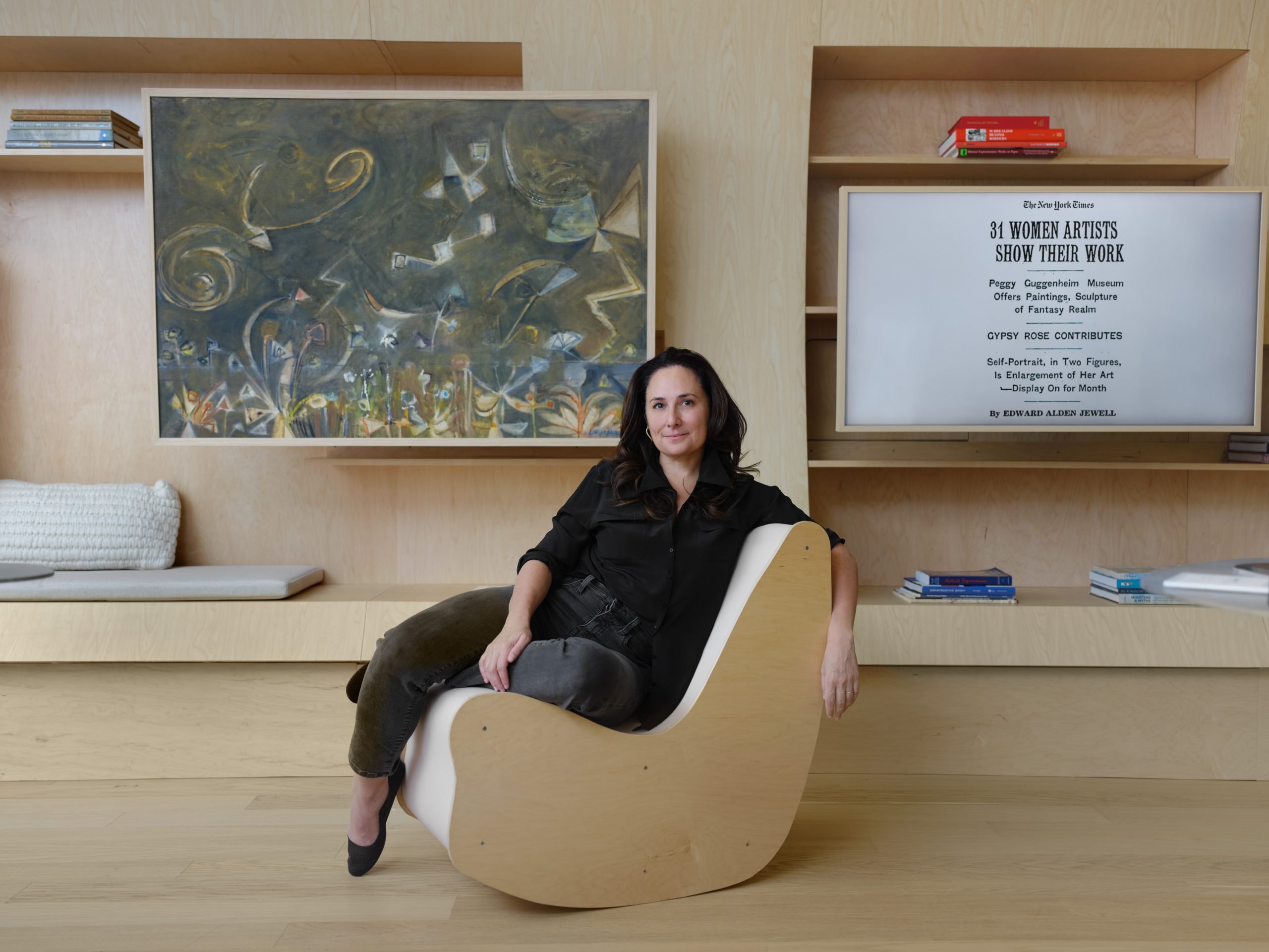 Jenna Segal photographed in her office—the site of the exhibition—at 30 West 57th Street. The painting behind her is Jacqueline Lamba's Roxbury Astres (1946). Photograph by Frances Tyska.