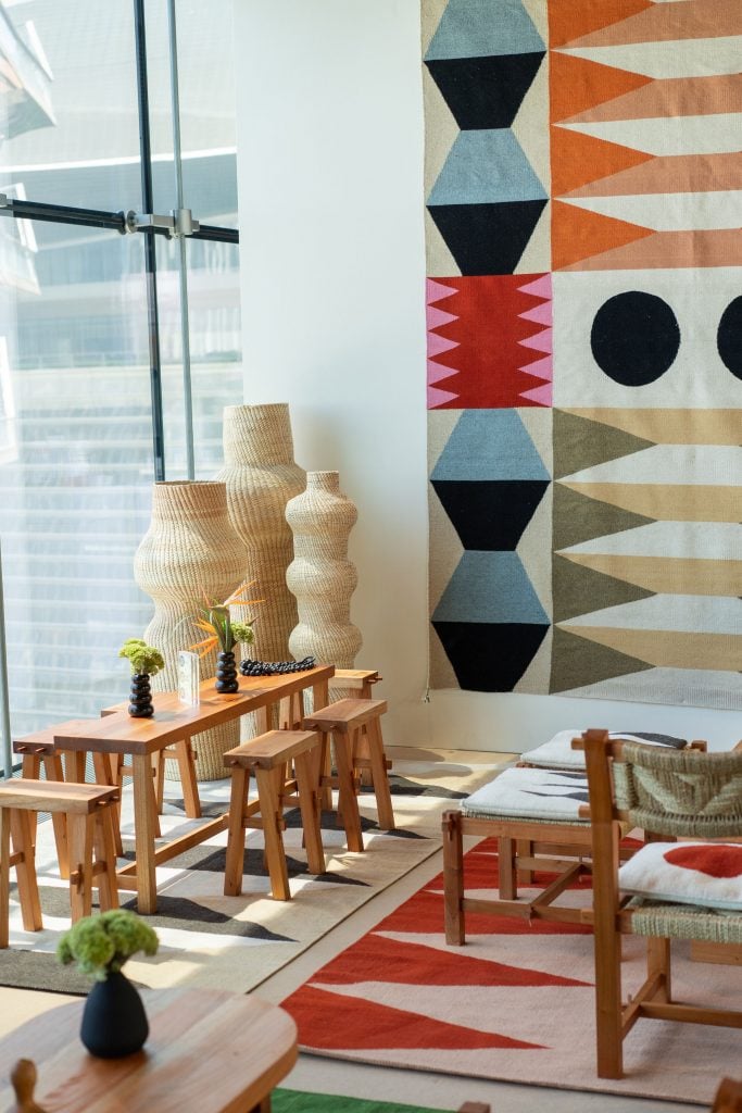 Javier Reyes's colorful textiles contrast wonderfully with his monotone woven vases. Courtesy of Maestro Dobel. 