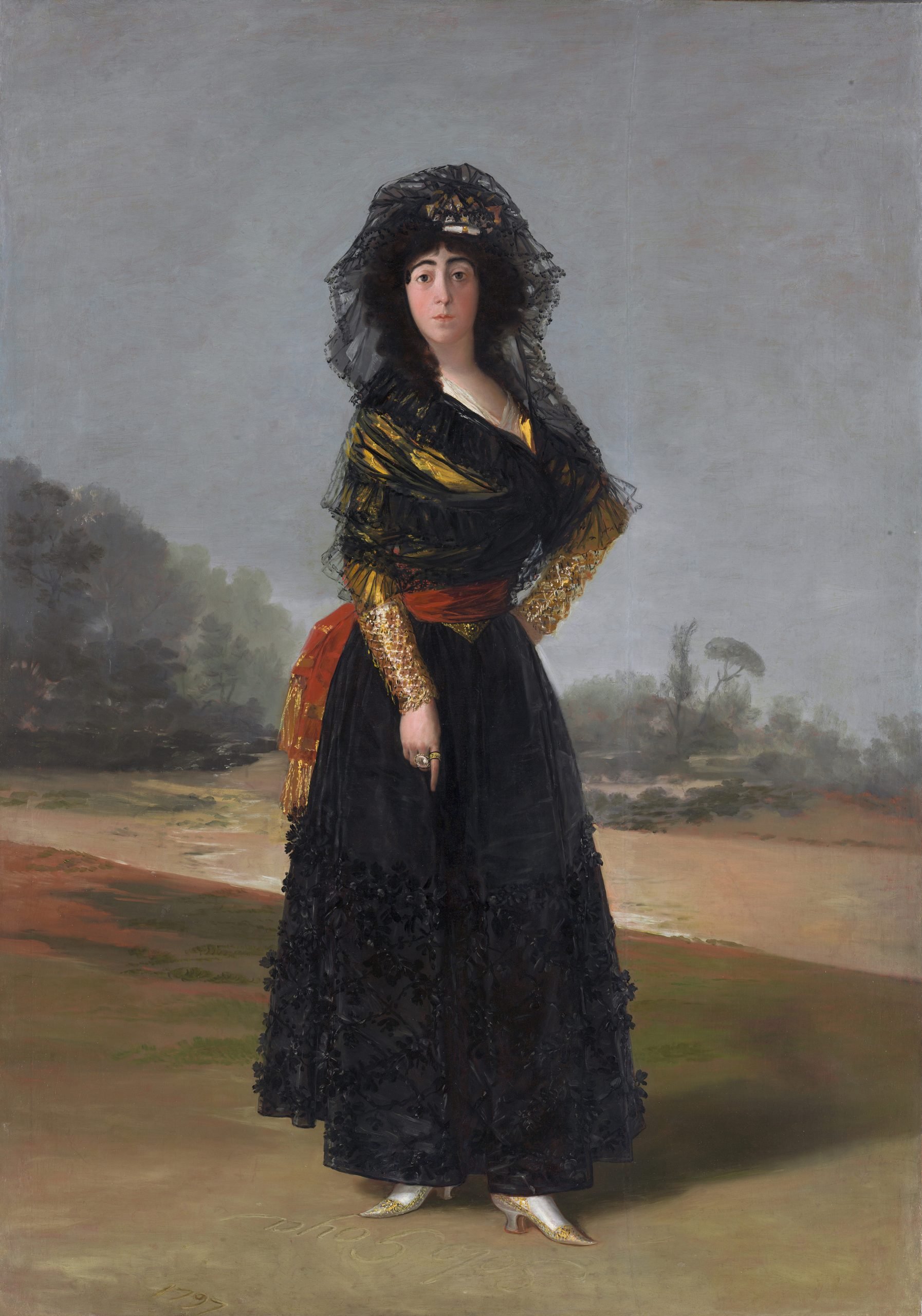 A Old Master style full-length formal portrait of a woman staring out of the canvas in a gray and brown landscape. She is wearing a long, full black skirt with a red sash, a golden yellow top with ornate sleeves, and a black lace Spanish shawl wrapped around her head and torso..