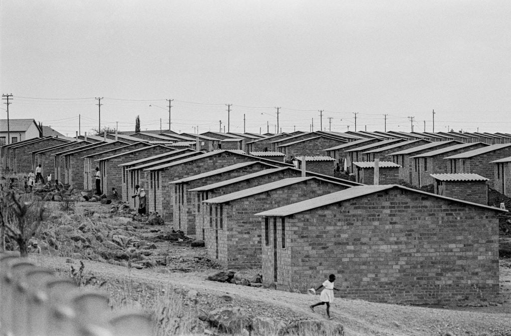 Ernest Cole, from <em>House of Bondage</em>. Acres of identical four-room houses on nameless streets. Many were hours by train from city jobs. Photo ©Ernest Cole, courtesy of Magnum Photos.
