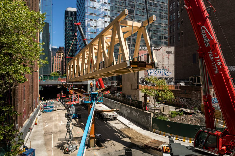The installation of the new Timber Bridge, connecting the High Line Spur's Woodland Bridge to Manhattan West and Moynihan Station. Photo by Andrew Frasz, courtesy of the High Line, New York. 