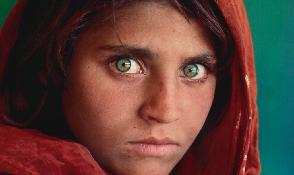 Steve McCurry, detail of Sharbat Gula, Afghan Girl, Pakistan (1984). Est. $12,000–$18,000.