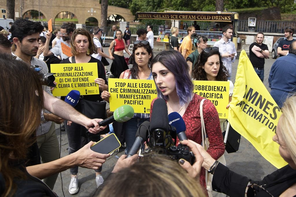 Environmental activist Ester Goffi speaks to the press at her court trial in the Vatican. The Ultima Generazione demonstrated in support of Goffi and Guido Viero outside the courthouse. Photo: Vincenzo Nuzzolese/SOPA Images/LightRocket via Getty Images.