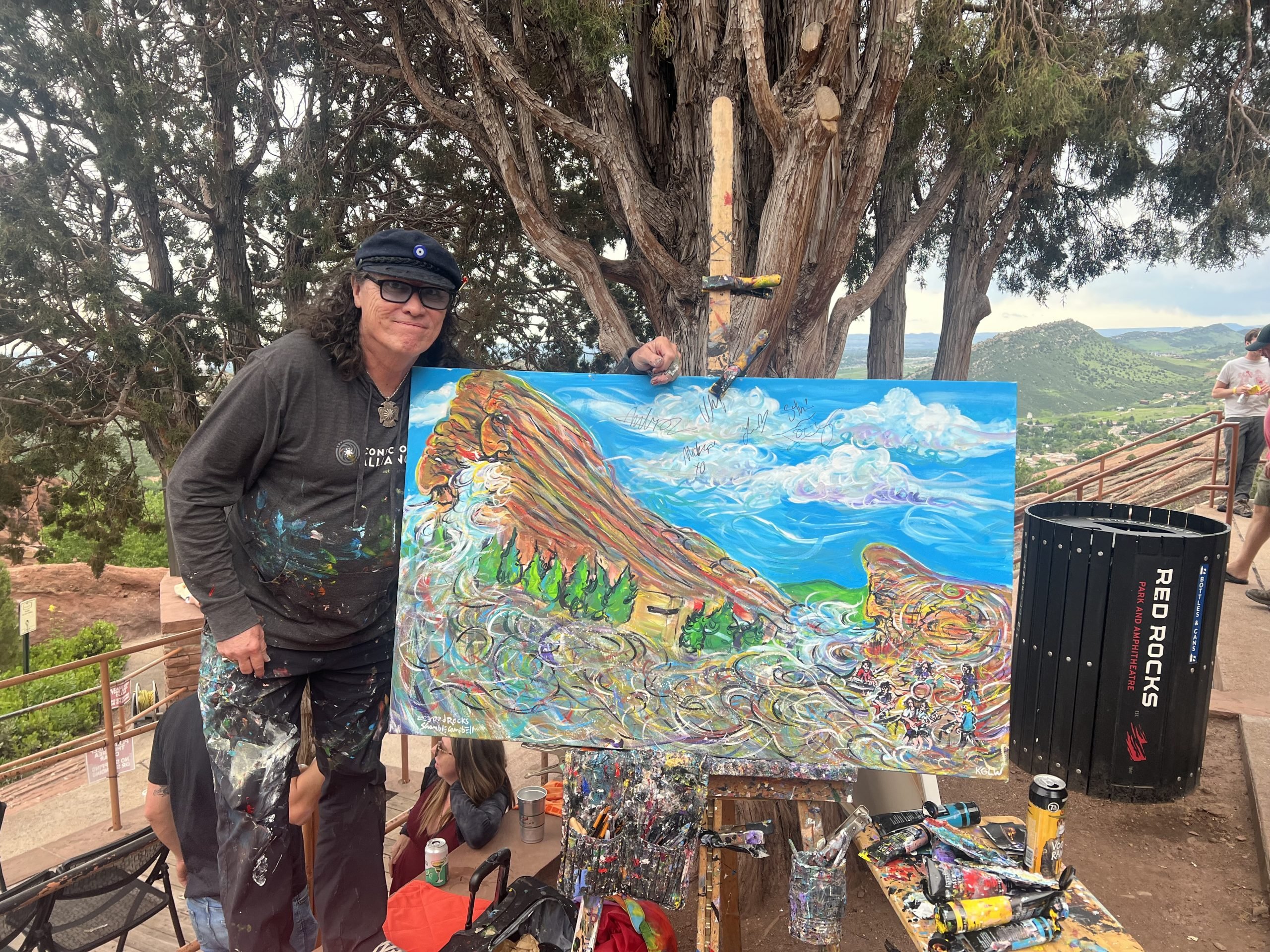 Keith "Scramble" Campbell with his painting of King Gizzard performing at Red Rocks Amphitheatre outside Denver. Photo by Sarah Cascone.