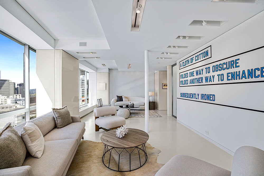 Lawrence Weiner, <em></noscript>A Cloth of Cotton Folded One Way to Enhance Subsequently Ironed</em> (2008).  Photo: Jeffrey Frisk.  Courtesy of Sotheby’s International Realty.” width=”1000″ height=”669″ srcset=”https://news.artnet.com/app/news-upload/2023/06/chara2.jpg 1000w, https://news.artnet.com/app/news-upload/2023/06/chara2-300×201.jpg 300w, https://news.artnet.com/app/news-upload/2023/06/chara2-50×33.jpg 50w” sizes=”(max-width: 1000px) 100vw, 1000px”/></p>
<p id=