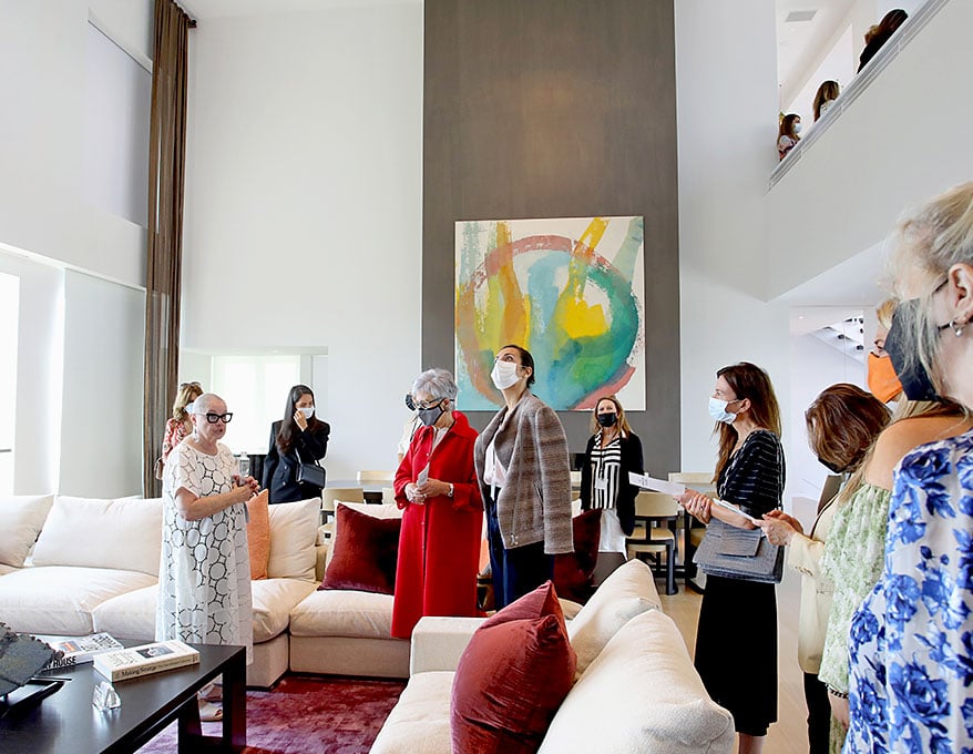 Chara Schreyer, in white, leads a tour of her art-filled Los Angeles home for the Visionary Women Luncheon, 2021. (Photo by Rachel Murray/Getty Images for Visionary Women)