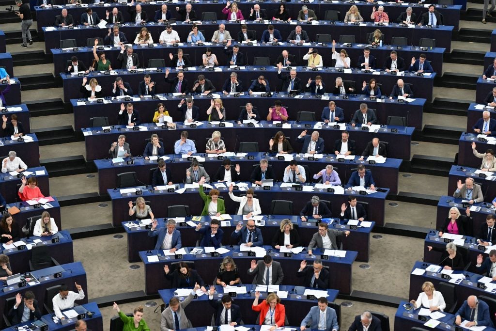 Members of the European Parliament vote on the Artificial Intelligence Act during a plenary session in Strasbourg, France, on June 14, 2023. (Photo by FREDERICK FLORIN / AFP) (Photo by FREDERICK FLORIN/AFP via Getty Images)