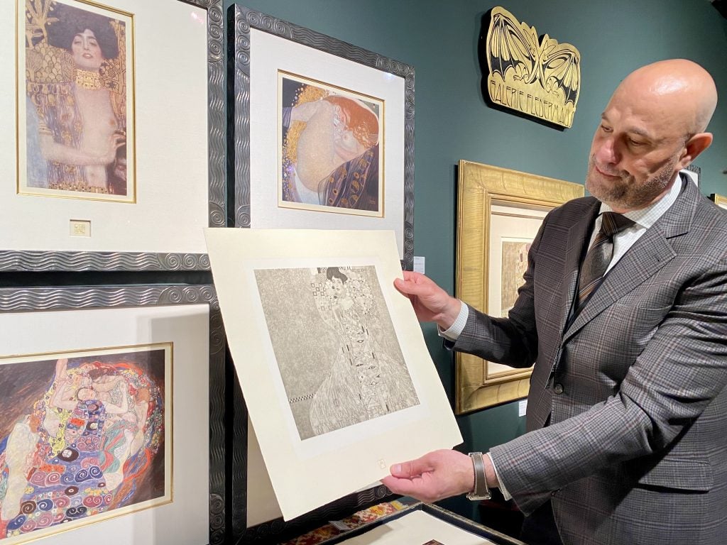 Jerry Suqi of Chicago's Galerie Fledermaus shows off rare portfolio of Gustav Klimt prints. at the Seattle Art Fair. Photo by Sarah Cascone.
