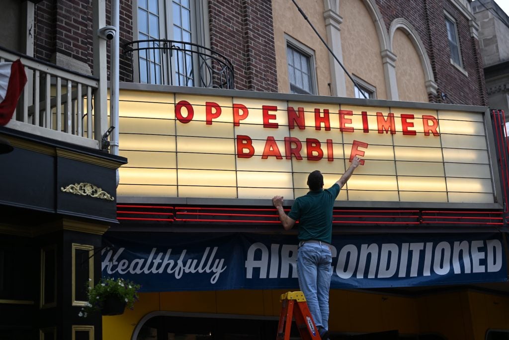 An employee adds letters for upcoming film releases 