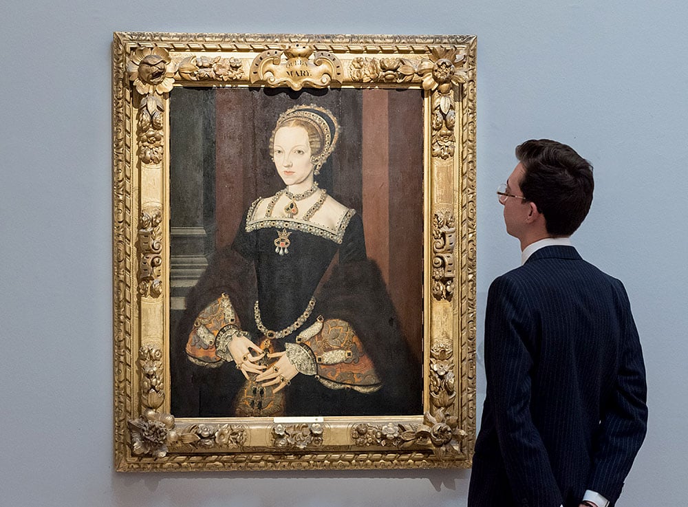 A visitor views a painting attributed to Master John, <em>Portrait of Katherine Parr (1512â"1548), Queen of England and Ireland</em> during a preview at Sotheby's London for the Old Master & 19th Century Paintings Evening Auction. (Photo: Wiktor Szymanowicz/Anadolu Agency via Getty Images)