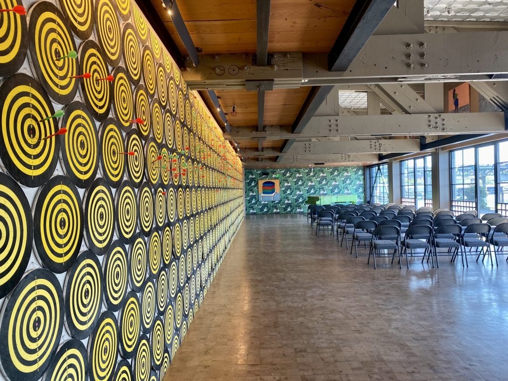 Jacob Dahlgren, <em>I, the world, things, life</eM>, a wall of dartboards, at the Boathouse, Dale Chihuly's Seattle studio. Photo by Sarah Cascone. 