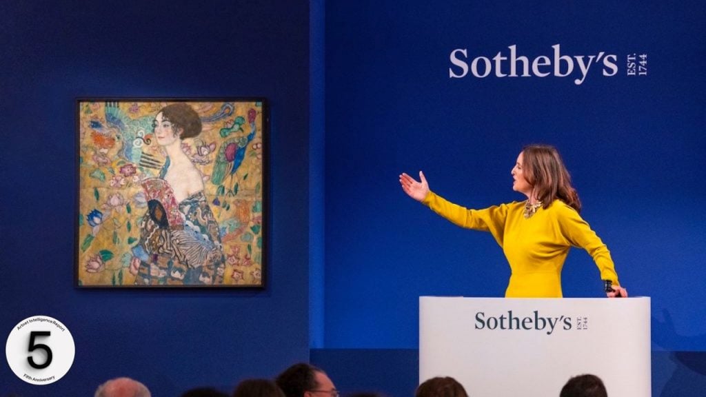 Auctioneer Helena Newman with Gustav Klimt's record-breaking Dame mit Fächer (Lady with a Fan). Photo by Haydon Perrior, Image courtesy Sotheby's.