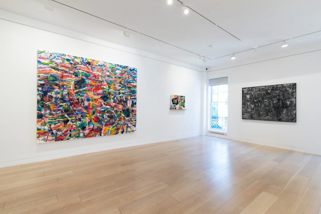 Installation view of Goodman New York new office and exhibition space. (L to R) artwork by Misheck Masamvu, Zineb Sedira, and David Koloane. Image courtesy Goodman Gallery.