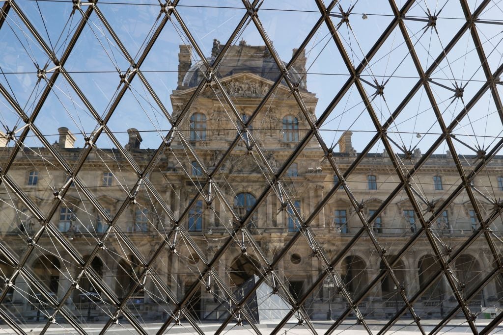 A picture taken on June 23, 2020 shows the Louvre pyramid by Chinese architect Ieoh Ming Pei, and the Louvre Museum in Paris. Photo by Thomas Samson/AFP via Getty Images.
