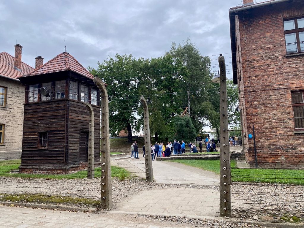 A gate at the Auschwitz concentration camp. Photo by Sarah Cascone. 