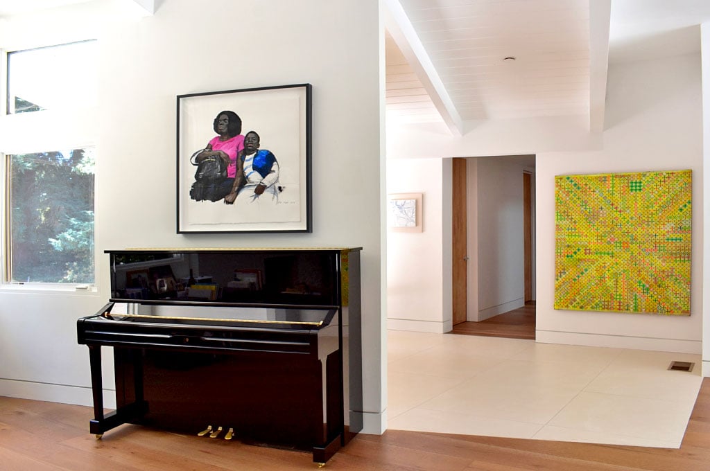 Left: Wang Xingwei’s painting above the piano. Right: Ding Yi’s <em>Appearance of Crosses</em> (2001). Courtesy of the collectors.