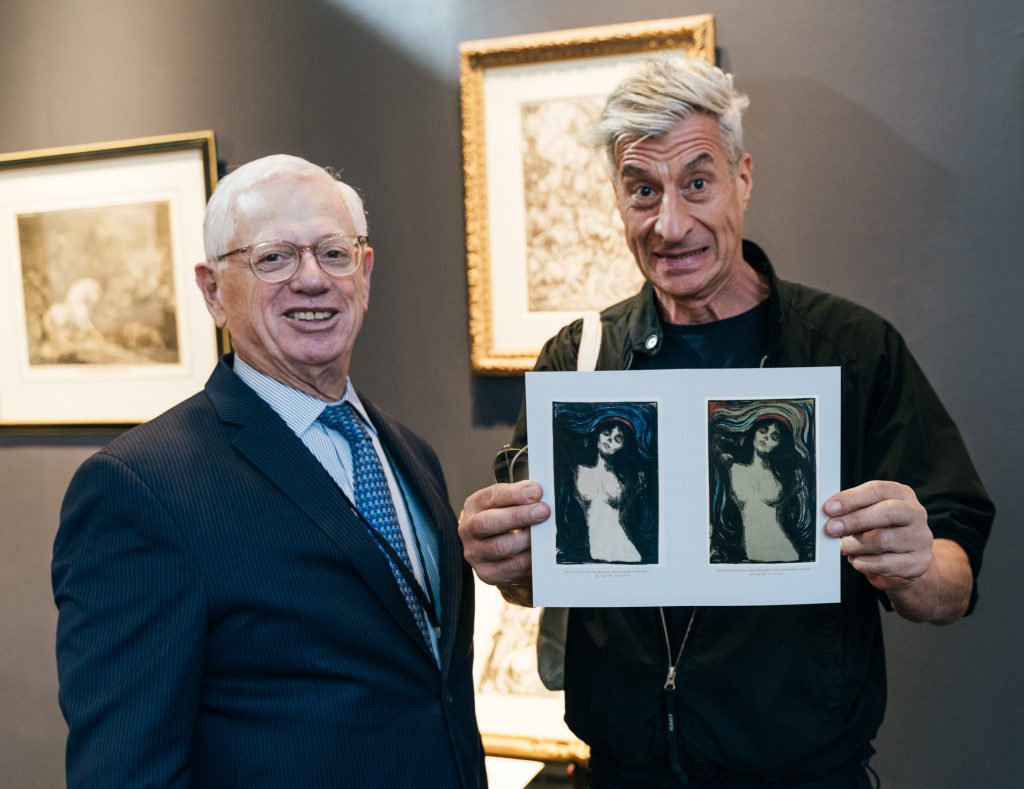 David Tunick and Maurizio Cattelan with reproductions of Edvard Munch's Madonna at the IFPDA Print Fair 2023. Photo by by Annie Forrest.