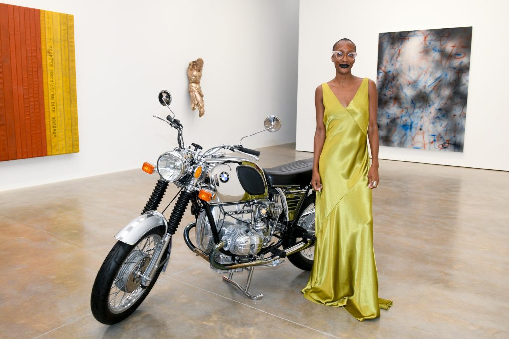 Courtney Willis Blair poses with a sculpture by Tiona Nekkia McClodd