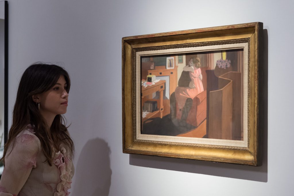 A gallery staff member looks at a painting by Felix Vallotton, Cinq heures (1898), during a photocall at Christie's