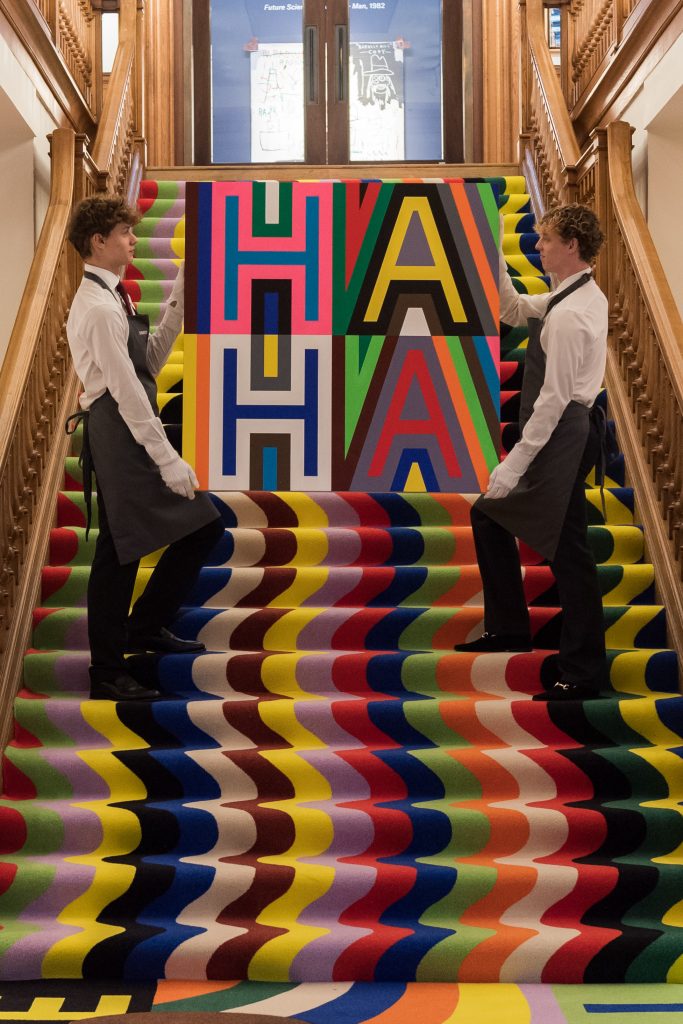 Art handlers carry an artwork by Lakwena Maciver titled Know who we are (2022), estimate £8,000-12,000 over the installation TENDER, LOVING, CARE, 2023, during a photocall at Christie's auction house for the first artist's takeover of the historic headquarters in St James's in London, United Kingdom on October 06, 2023. Photo by Wiktor Szymanowicz/Future Publishing via Getty Images.